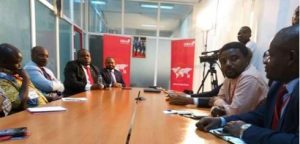 Pressmen and a host of UBA workers listening to Martin Che-UBA CEMAC Regional Director-sitting extreme left with red tie