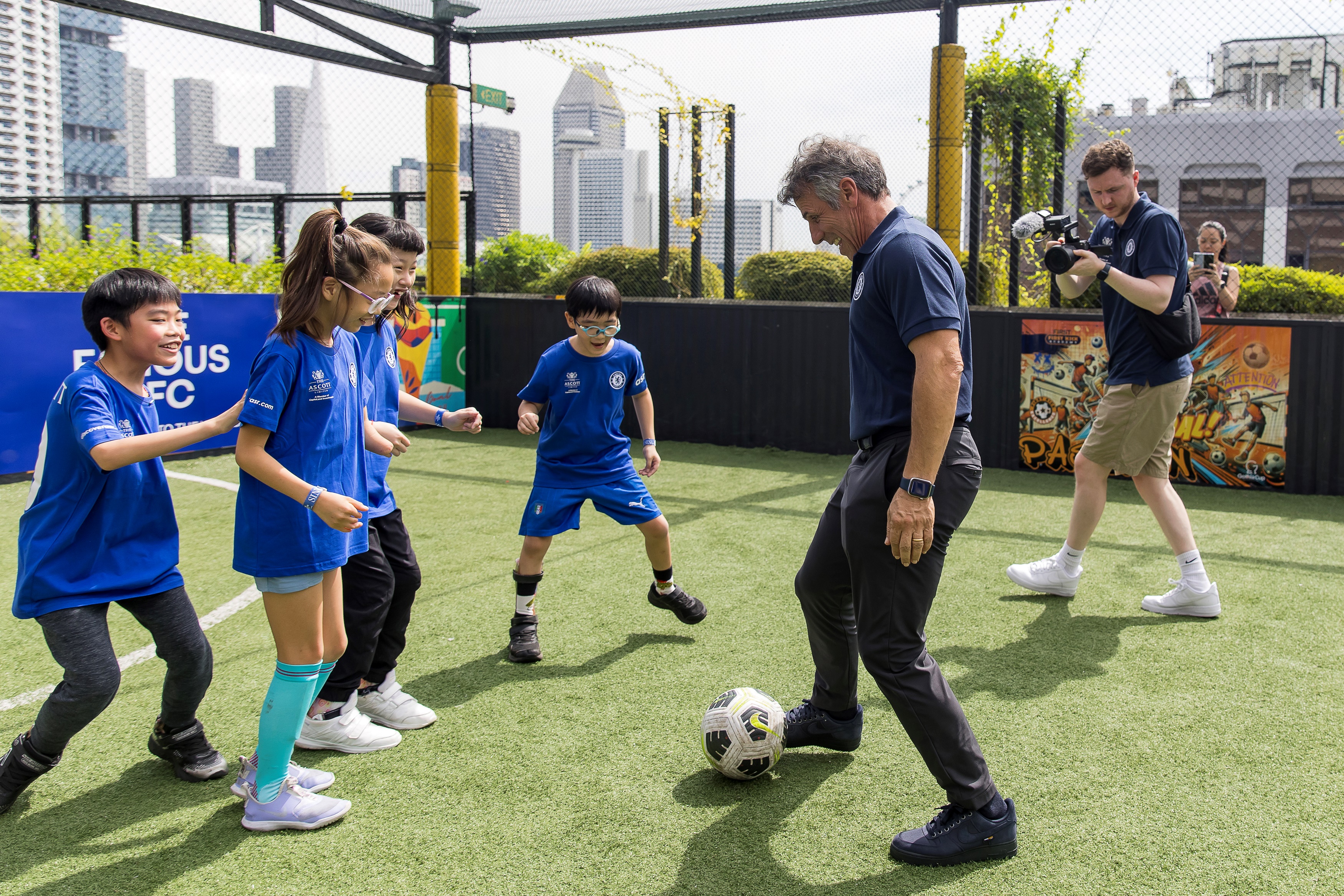 Chelsea Football Club legend Gianfranco Zola enjoying a friendly game with young beneficiaries from the Singapore Disability Sports Council on Saturday, 30 November, at the rooftop futsal court in Funan. The football coaching clinic was part of The Famous CFC, Chelsea’s flagship international fan engagement event presented by The Ascott Limited (Ascott), underscoring both organisations' commitment to supporting local communities and promoting disability inclusion.